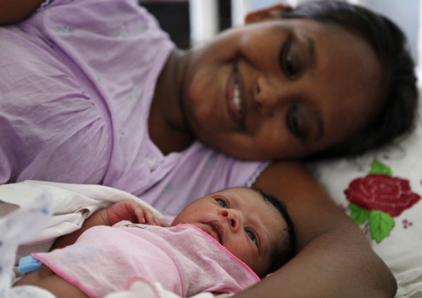 الأم السيرلانكية دانوشكا بيريرا تحتضن طفلتها المولودة حديثا