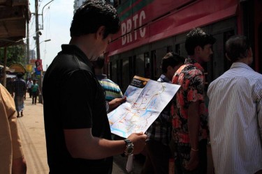 A bus rider check the bus map. Photo: Nazim Uddin Khan Price. Images courtesy by Urban Launchpad
